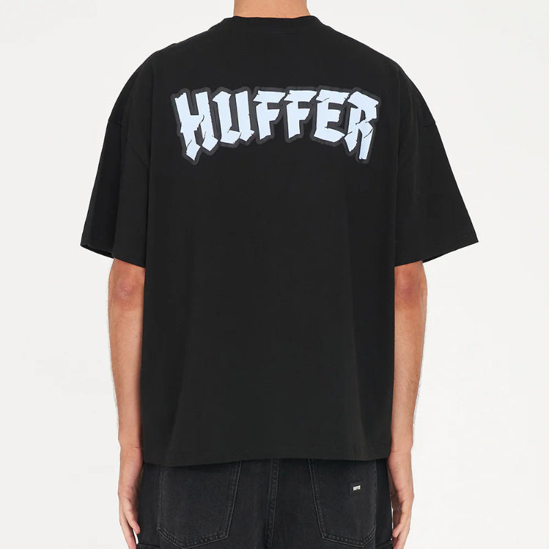 Person wearing a black t-shirt with 'Huffer' logo on the back against a white background