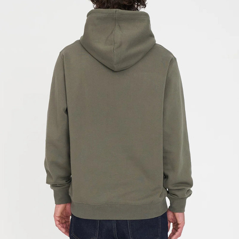 A person viewed from the back wearing an olive green pullover hoodie and dark blue jeans against a plain light gray studio background.
