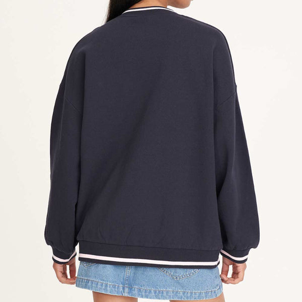 Person wearing a navy blue sweatshirt on a white background