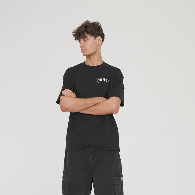 Person wearing a black t-shirt and cargo shorts on a white background