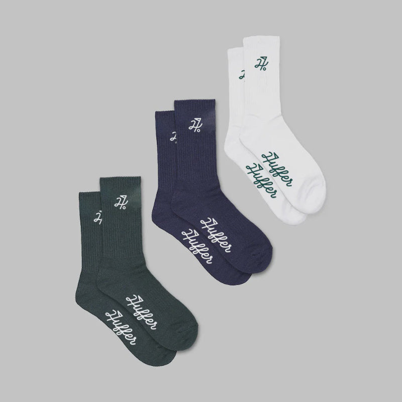 Set of 3 socks in green, navy, and white on a gray background