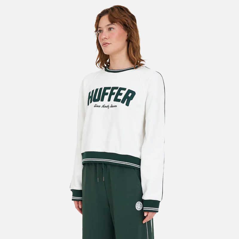 Person wearing a white sweatshirt with 'HUFFER' branding on a white background