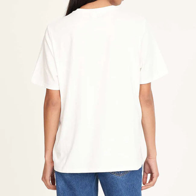 Person wearing a white t-shirt and blue jeans on a plain background