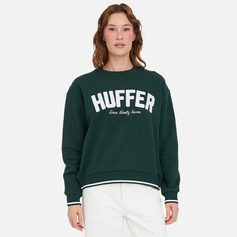 Person wearing a green sweatshirt with 'HUFFER' branding on a white background