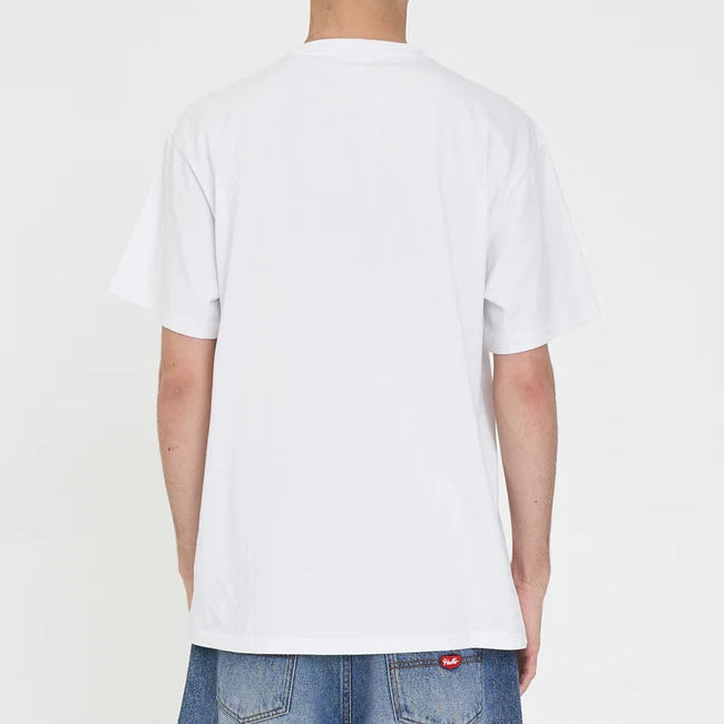 Person wearing a plain white t-shirt and blue jeans on a light gray background