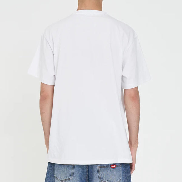 Person wearing a plain white t-shirt and blue jeans on a light gray background