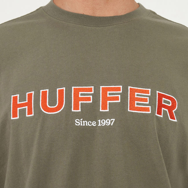 Green t-shirt with 'HUFFER Since 1997' text on a plain background