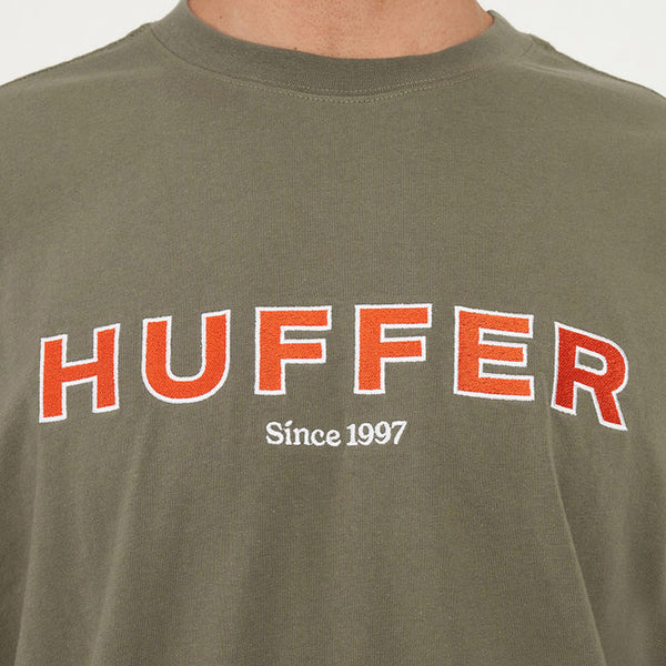 Green t-shirt with 'HUFFER Since 1997' text on a plain background