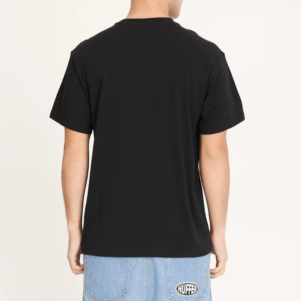 Person wearing a black t-shirt with a visible brand logo on the back, standing against a plain background.