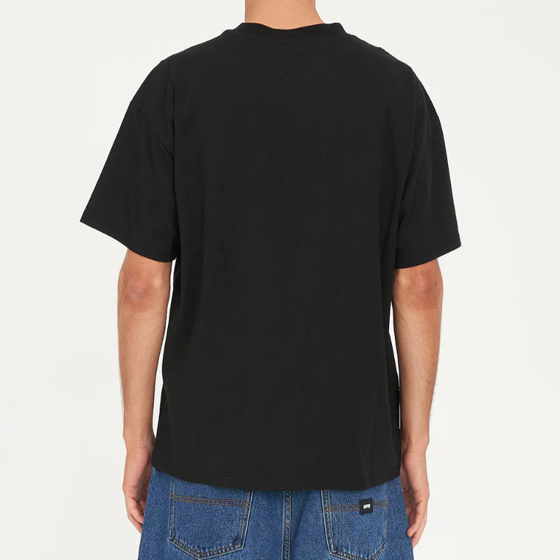 Person wearing a black t-shirt and blue jeans on a white background
