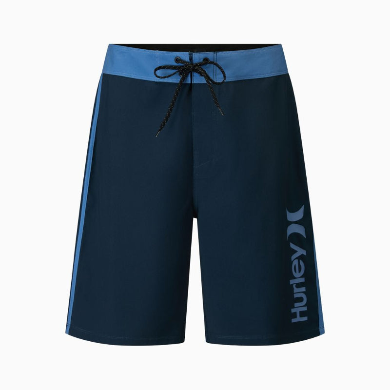 Navy blue board shorts with a light blue waistband and side stripe, featuring a black drawstring and a white Hurley logo on the lower left leg.