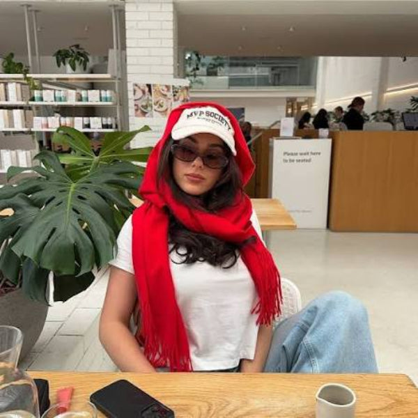 A women wearing le specs dont cha sunglasses in a mall