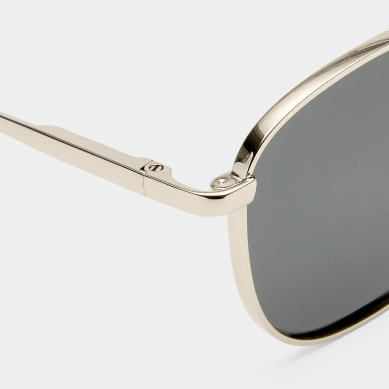 silver framed sunglasses with dark lenses on a light gray background