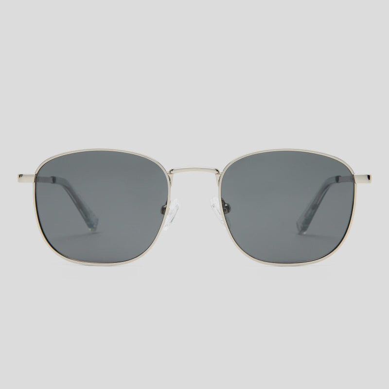 Oversized square sunglasses with a thin gold metal frame and dark gray lenses, shown against a light gray background.