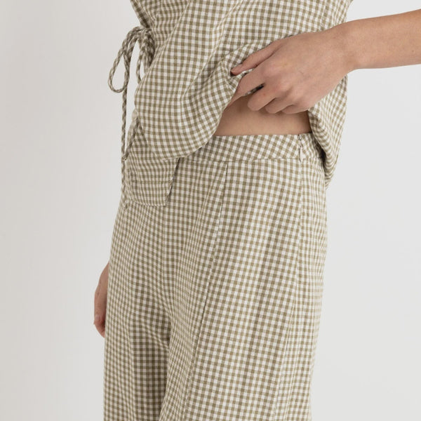 Checkered pants worn by a person on a plain background