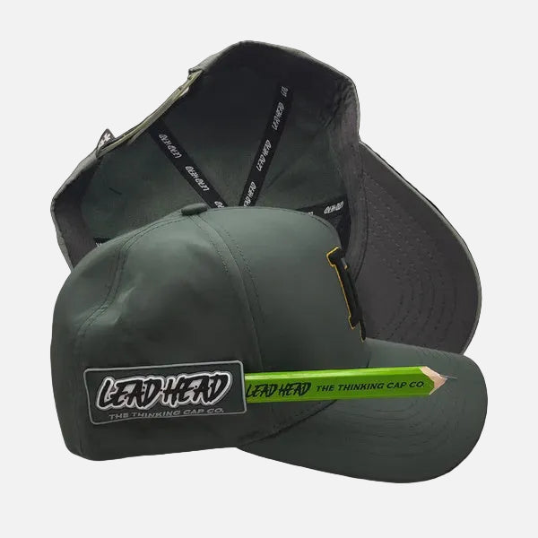 An olive green snapback cap shown from the front and back against a black background. The front features a rectangular patch that reads 'LEAD HEAD THE THINKING CAP CO.