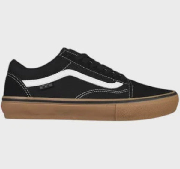 A classic low-top skate shoe in black canvas with a white side stripe, black laces, and a brown gum sole, shown from a side profile view against a light gray background.