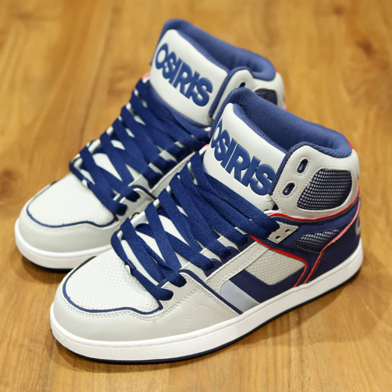Pair of white and blue Osiris sneakers on a wooden floor