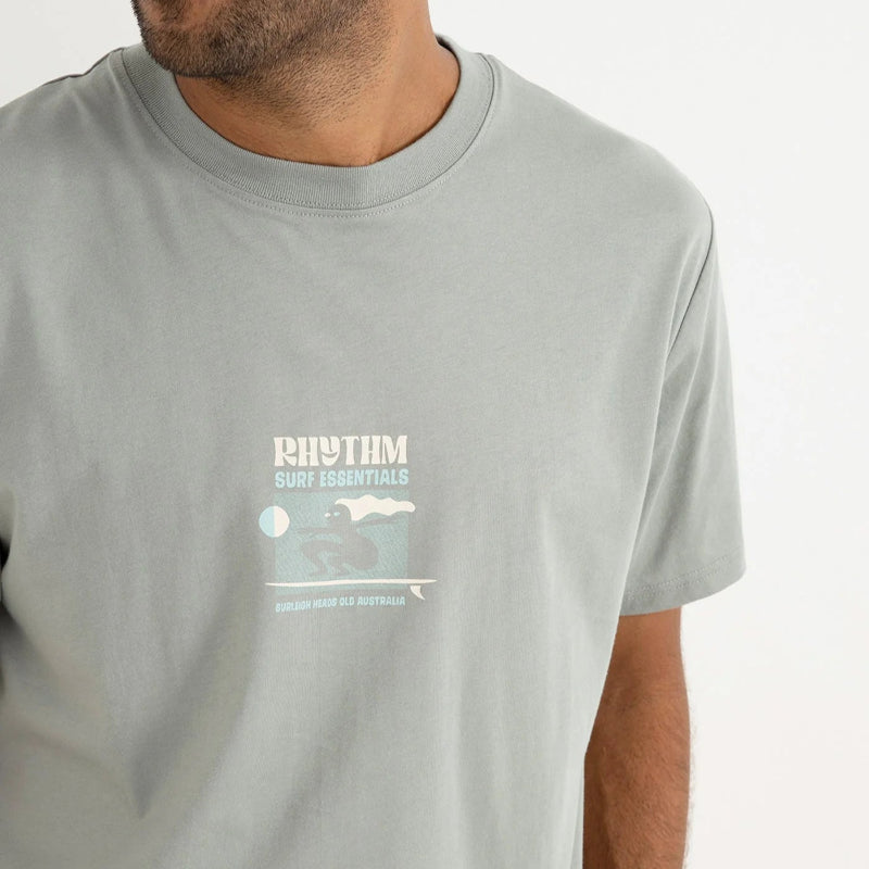 Man wearing a gray t-shirt with 'Rhythm' branding on a white background