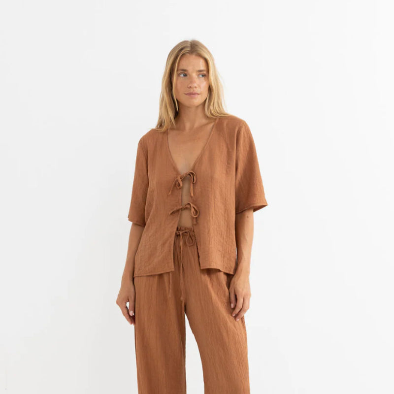 Woman wearing a brown outfit on a white background