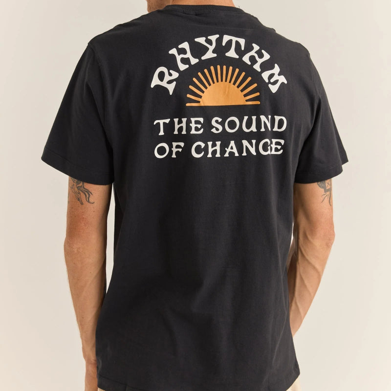 Person wearing a black t-shirt with 'Rhythm: The Sound of Change' text and logo on the back.