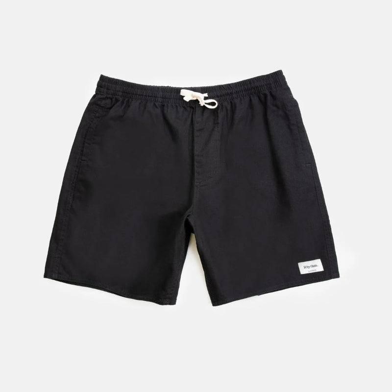Black shorts with a brand logo on a light gray background