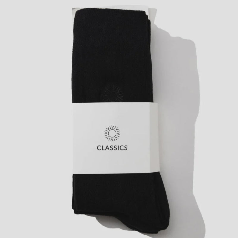 Pack of black socks  on a light gray background