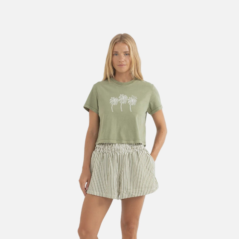 Woman wearing a green t-shirt and striped shorts on a white background