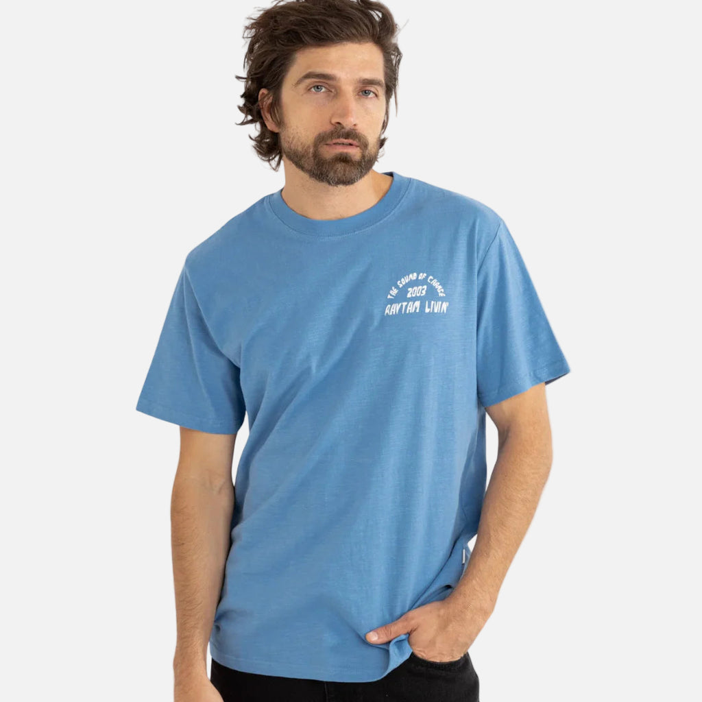 Man wearing a blue t-shirt with text on a white background