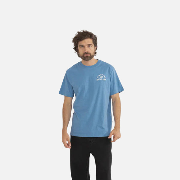Man wearing a blue t-shirt with a logo on a white background