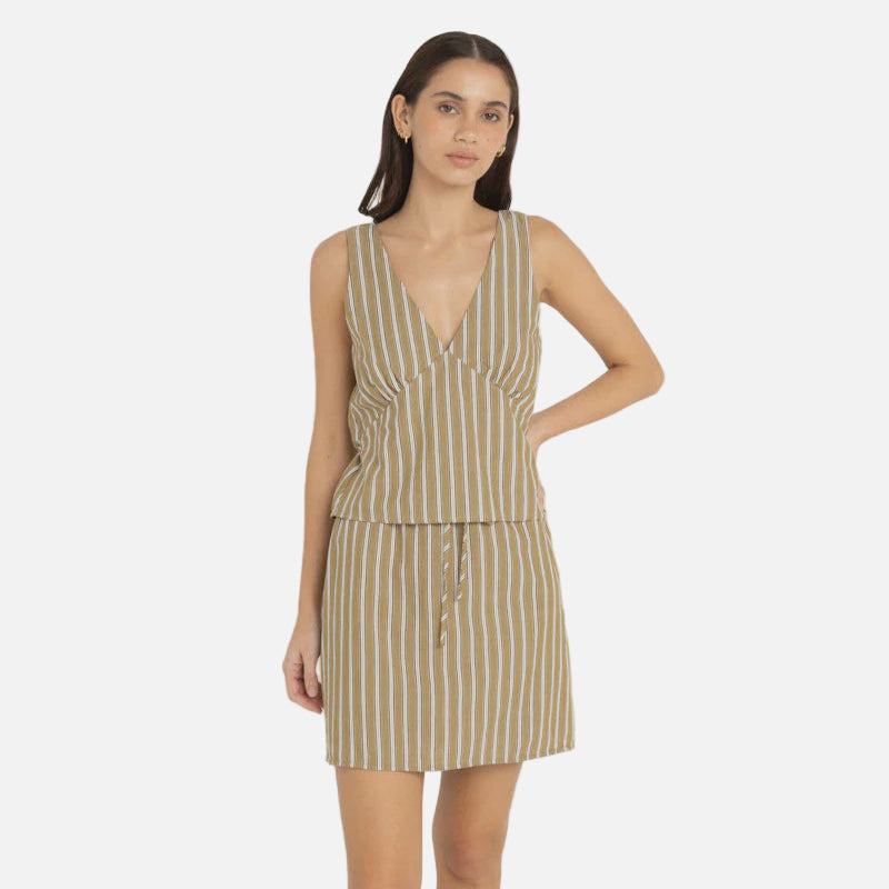 Woman wearing a striped top and skirt on a white background