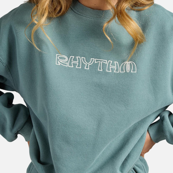 Teal sweatshirt with 'RHYTHM' text on a gray background