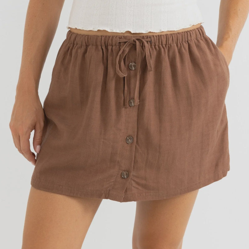 Brown button-up skort worn by a person on a white background