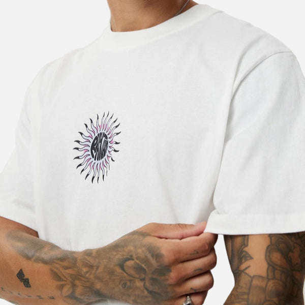 Man wearing a white t-shirt with a black and purple sunflower design on a plain background