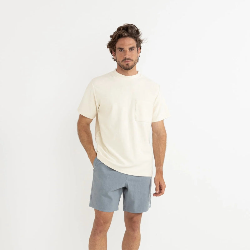 Man wearing a white t-shirt and gray shorts on a white background