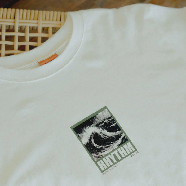 White t-shirt with a logo on a wooden surface