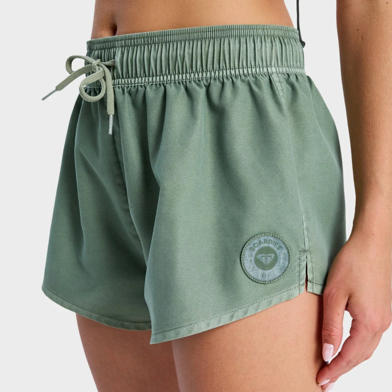 Green shorts with a logo on a white background