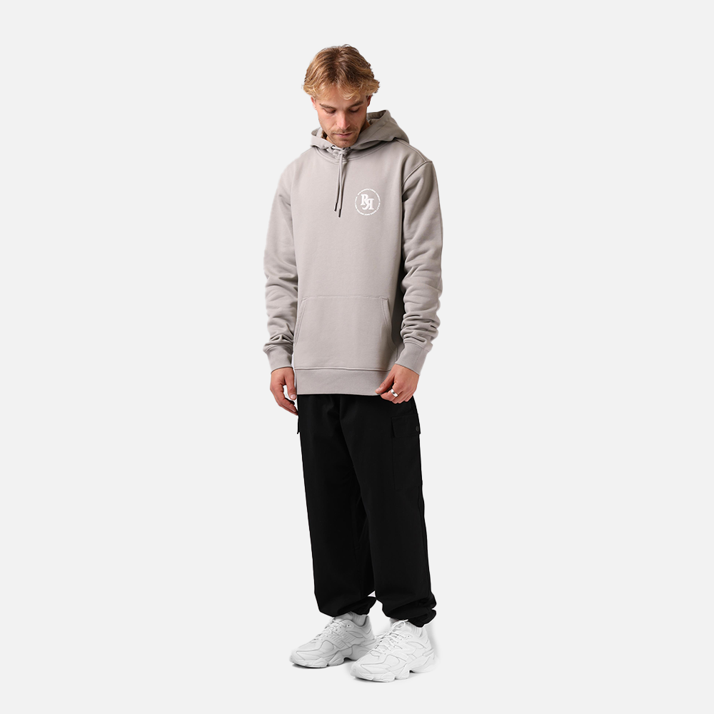 Person wearing a tan hoddle rpm branding on a white background