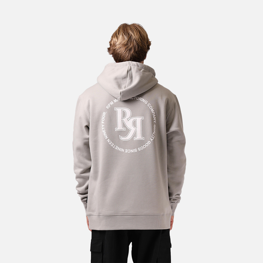 Person wearing a gray hoodie with a logo on the back against a white background