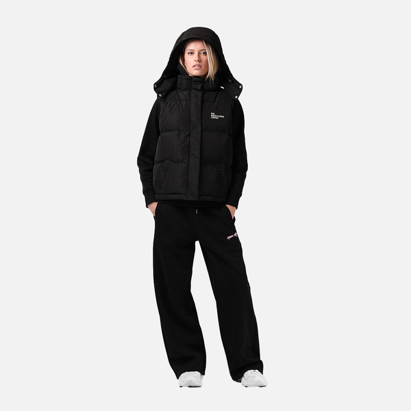 Person wearing a black puffer jacket and pants on a white background