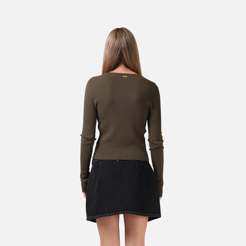 Woman wearing a green sweater and black skirt on a white background