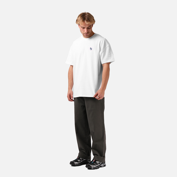 Person wearing a white t-shirt and black pants on a white background