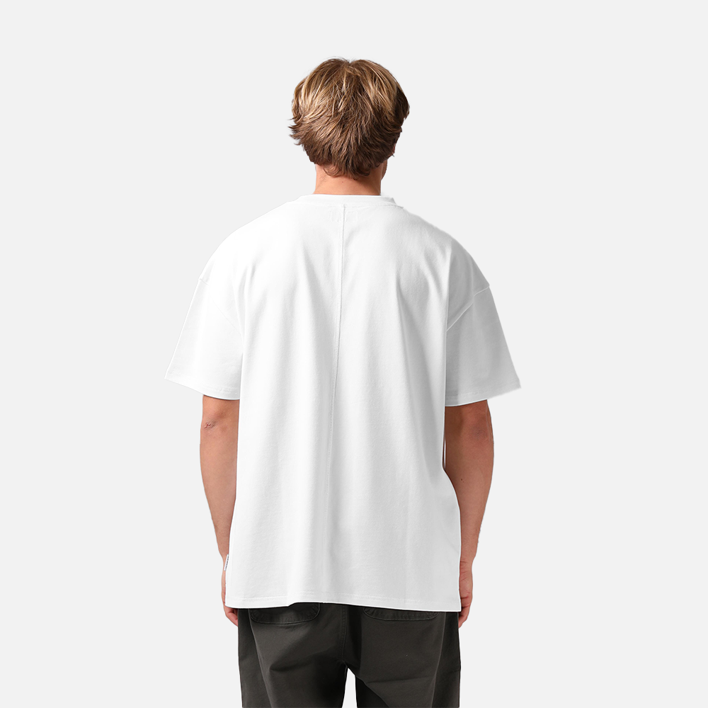 Person wearing a white t-shirt on a plain background