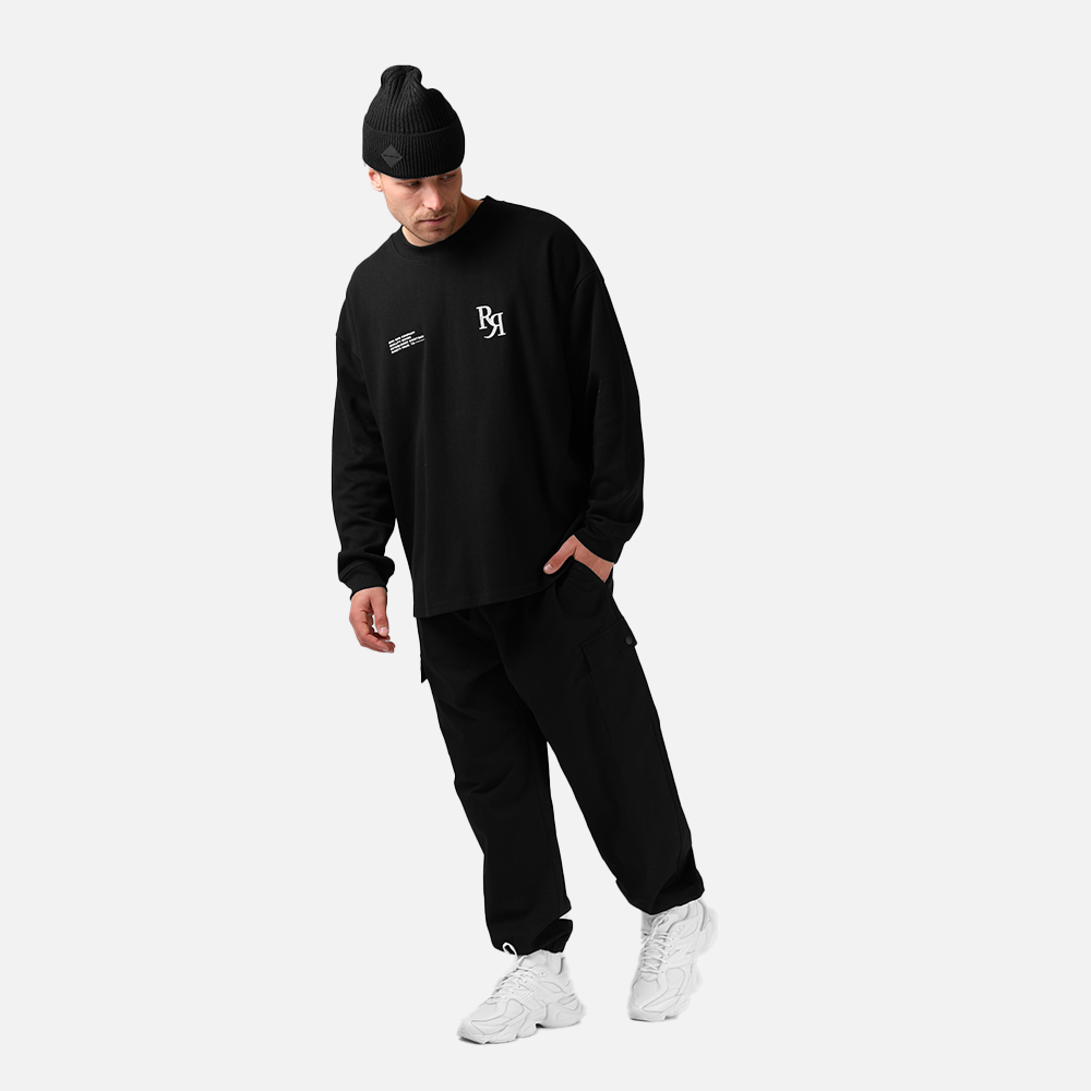 Person wearing a black tracksuit with a logo on a white background