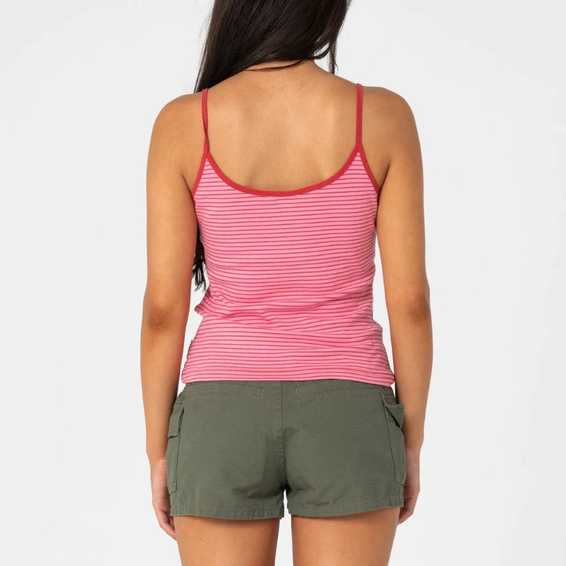 A woman shown from the back wearing a pink and white striped camisole tank top with thin straps and olive green cargo shorts, against a plain light gray studio background.