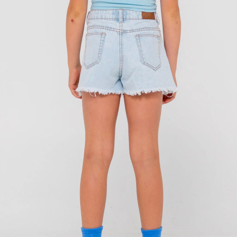 Person wearing light blue denim shorts and blue socks on a white background