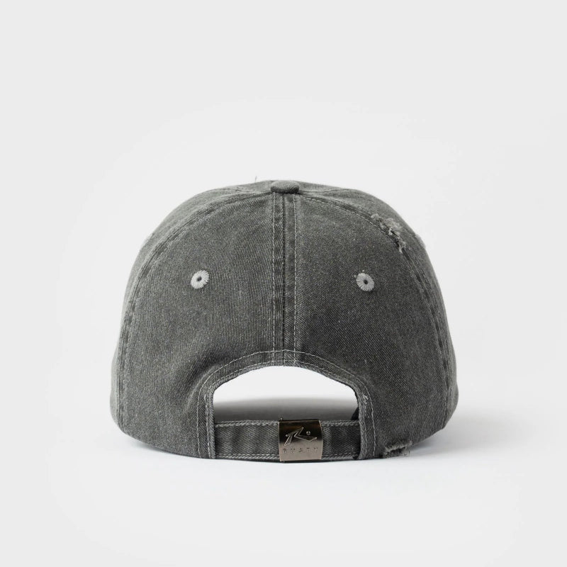 A washed dark gray baseball cap shown from the back, featuring a curved back strap with a small metal brand tag, set against a plain light gray background.