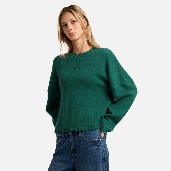 a women with a green sweeter and blue shorts on