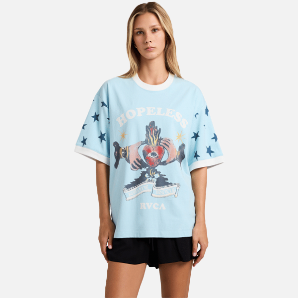 Person wearing a light blue graphic t-shirt with text and design on a white background