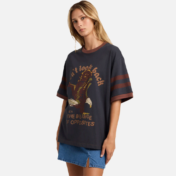 a women wearing a black and brown t-shirt with a big logo on the front